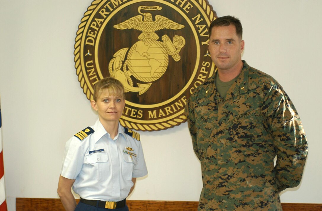 MARINE CORPS BASE CAMP LEJEUNE, N.C. - Marines from the Military Justice Office, Legal Services Support Section, Headquarters and Service Battalion, 2d Force Service Support Group, welcomed a coastguardsman to their office here Jan. 10. Coast Guard Lt. Cdr. Patricia J. Hill, trial counsel, will be working alongside Marines like Maj. Stephen F. Keane, chief prosecutor, at LSSS for the next three months. (Official U.S. Marine Corps photo by Cpl. G. Lane Miley)