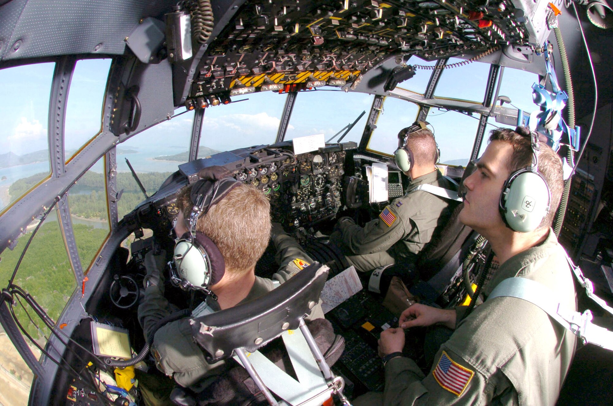 PHUKET, Thailand -- (From left) Maj. Brian Geronime, Capt. Jason Fodor and Staff Sgt. Michael Whipple take off in a C-130 Hercules after they transported an engineering assessment team here Jan. 8.  The crew is assigned to the 36th Airlift Squadron at Yokota Air Base, Japan.  The squadron first delivered relief supplies and equipment to tsunami-devastated areas in Thailand, Indonesia and Sri Lanka on Dec. 29. (U.S. Air Force photo by Master Sgt. Val Gempis) 
