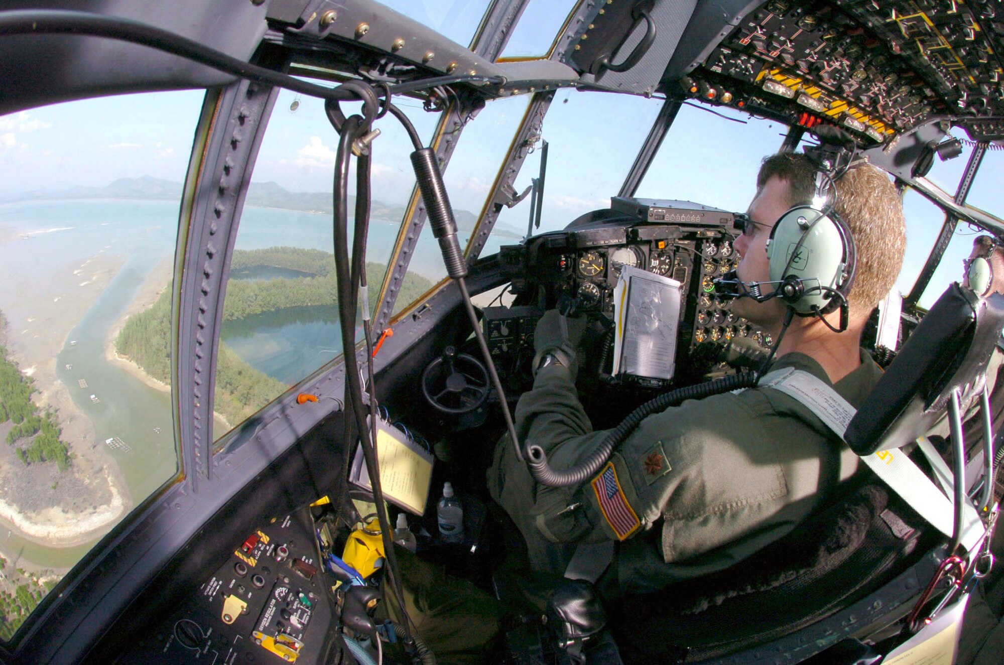 PHUKET, Thailand -- Maj. Brian Geronime takes off in a C-130 Hercules after transporting an engineering assessment team here Jan. 8.  He is a pilot assigned to the 36th Airlift Squadron at Yokota Air Base, Japan. The squadron first delivered relief supplies and equipment to devastated areas in Thailand, Indonesia and Sri Lanka, on Dec. 29.  (U.S. Air Force photo by Master Sgt. Val Gempis)