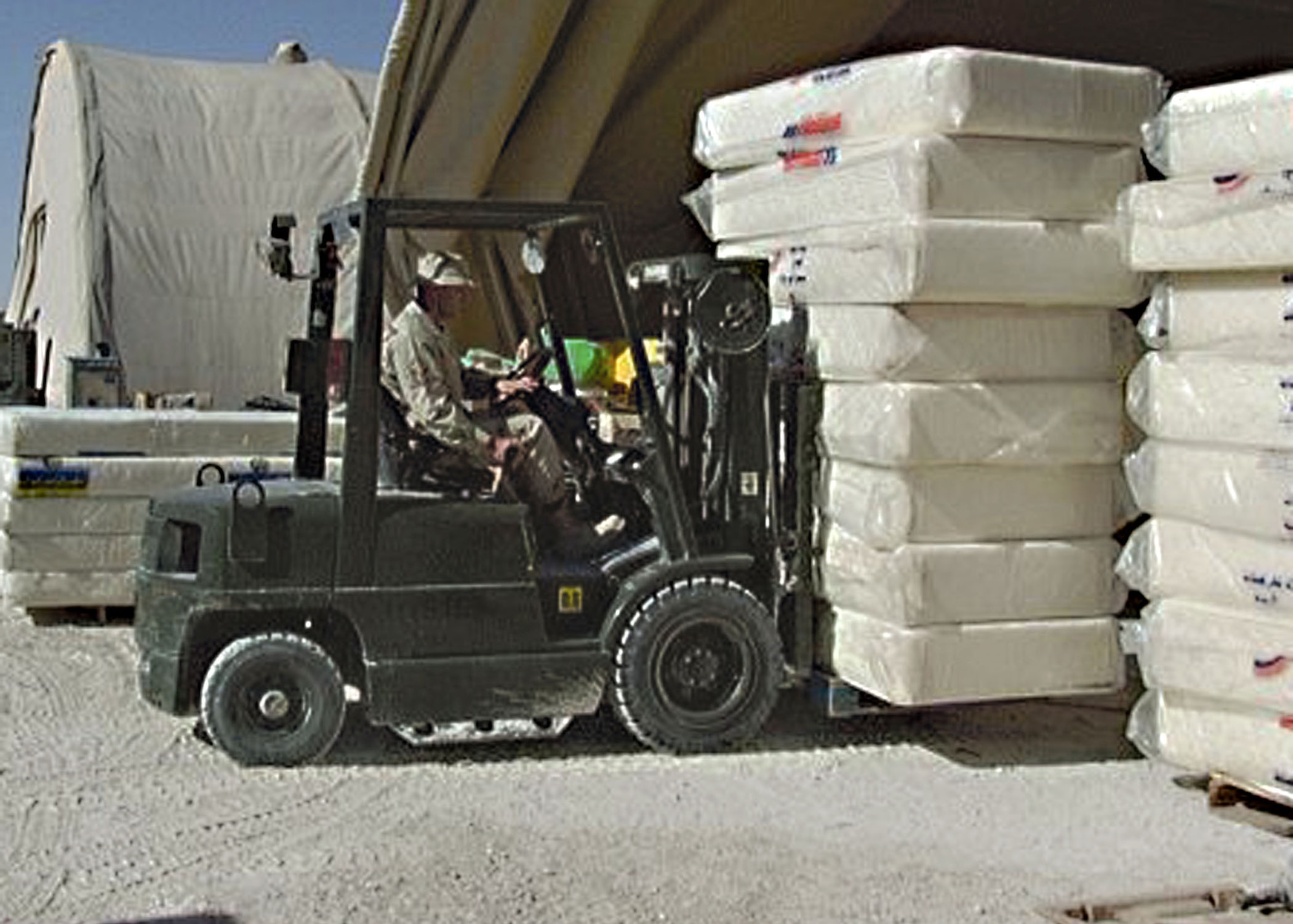 SOUTHWEST ASIA -- Master Sgt. John Brinchi moves mattresses donated to tsunami victims in Sri Lanka.  People from a forward-deployed location are working with host-nation officials to provide relief supplies to Southeast Asia.  Sergeant Brinchi is deployed to the 379th Expeditionary Logistics Readiness Squadron from Seymour Johnson Air Force Base, N.C.  (Courtesy photo)