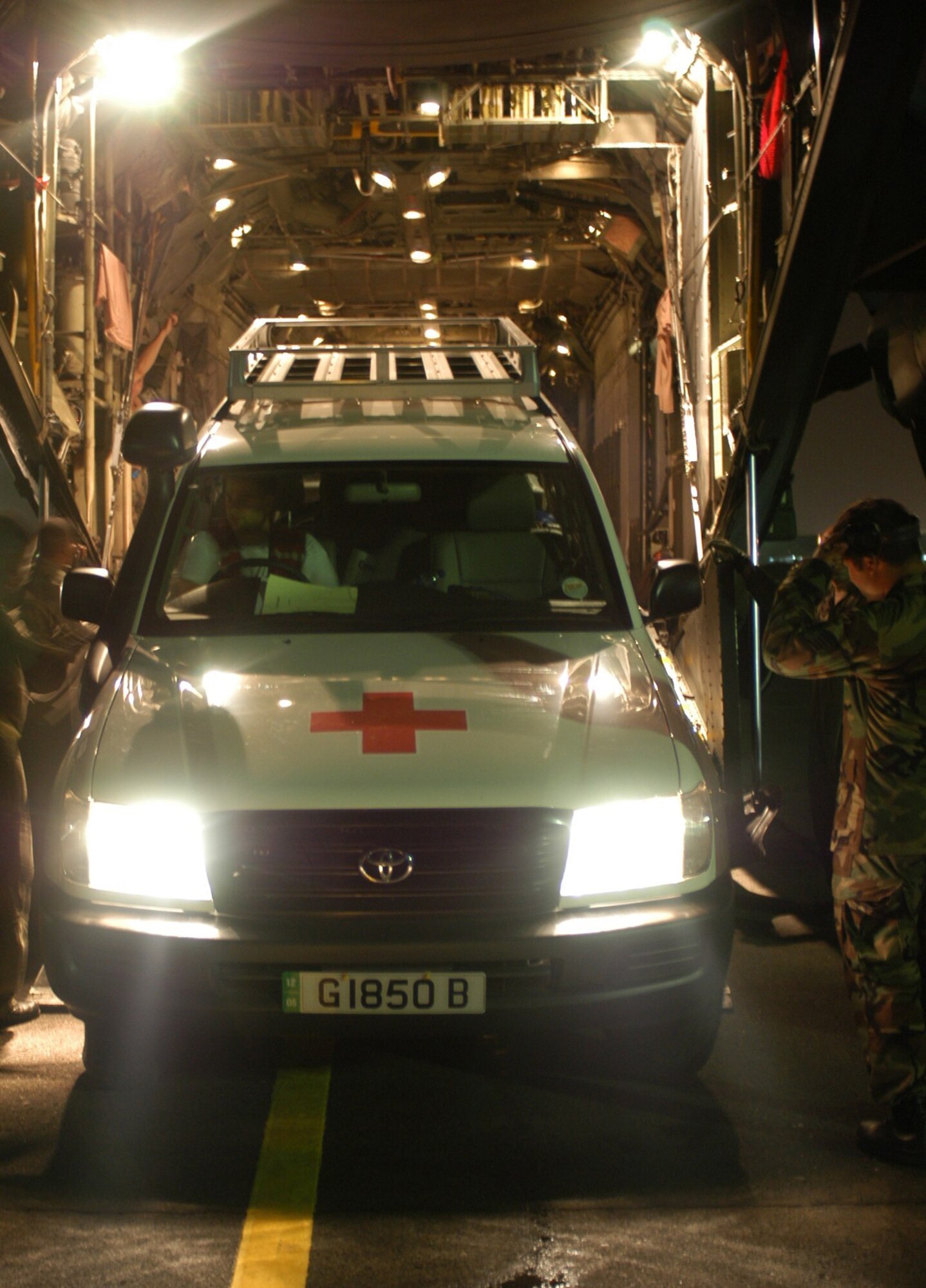 BANDA ACEH, Indonesia -- Loadmasters guide a Spanish Red Cross support vehicle off an MC-130H Combat Talon II here.  Dozens of flights have carried relief supplies and equipment into the region.  (U.S. Air Force photo by Master Sgt. Michael Farris)
