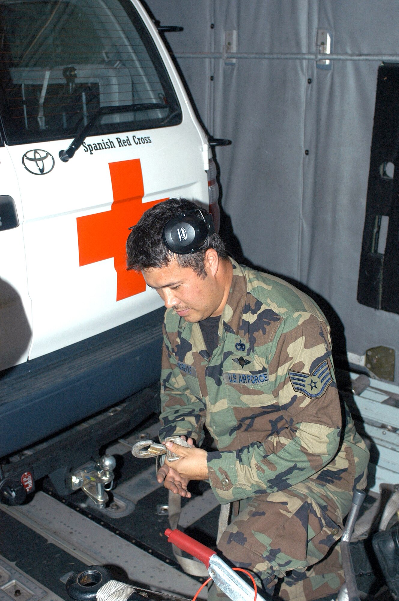 MEDAN, Indonesia -- A rigger with the 353rd Operations Support Squadron prepares to tiedown a Spanish Red Cross support vehicle in the cargo compartment of an MC-130H Combat Talon II here.  The vehicle was delivered to Banda Aceh.  (U.S. Air Force photo by Master Sgt. Michael Farris)
