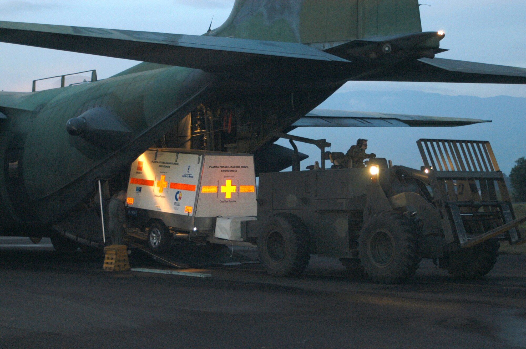 BANDA ACEH, Indonesia -- A Spanish Red Cross water purification trailer is taken off an MC-130H Combat Talon II here by aerial delivery support branch specialists.  Airmen of the 353rd Special Operations Group and Theater Special Operations Air Component help move tons of cargo daily at the tiny airfield.  (U.S. Air Force photo by Master Sgt. Michael Farris)
