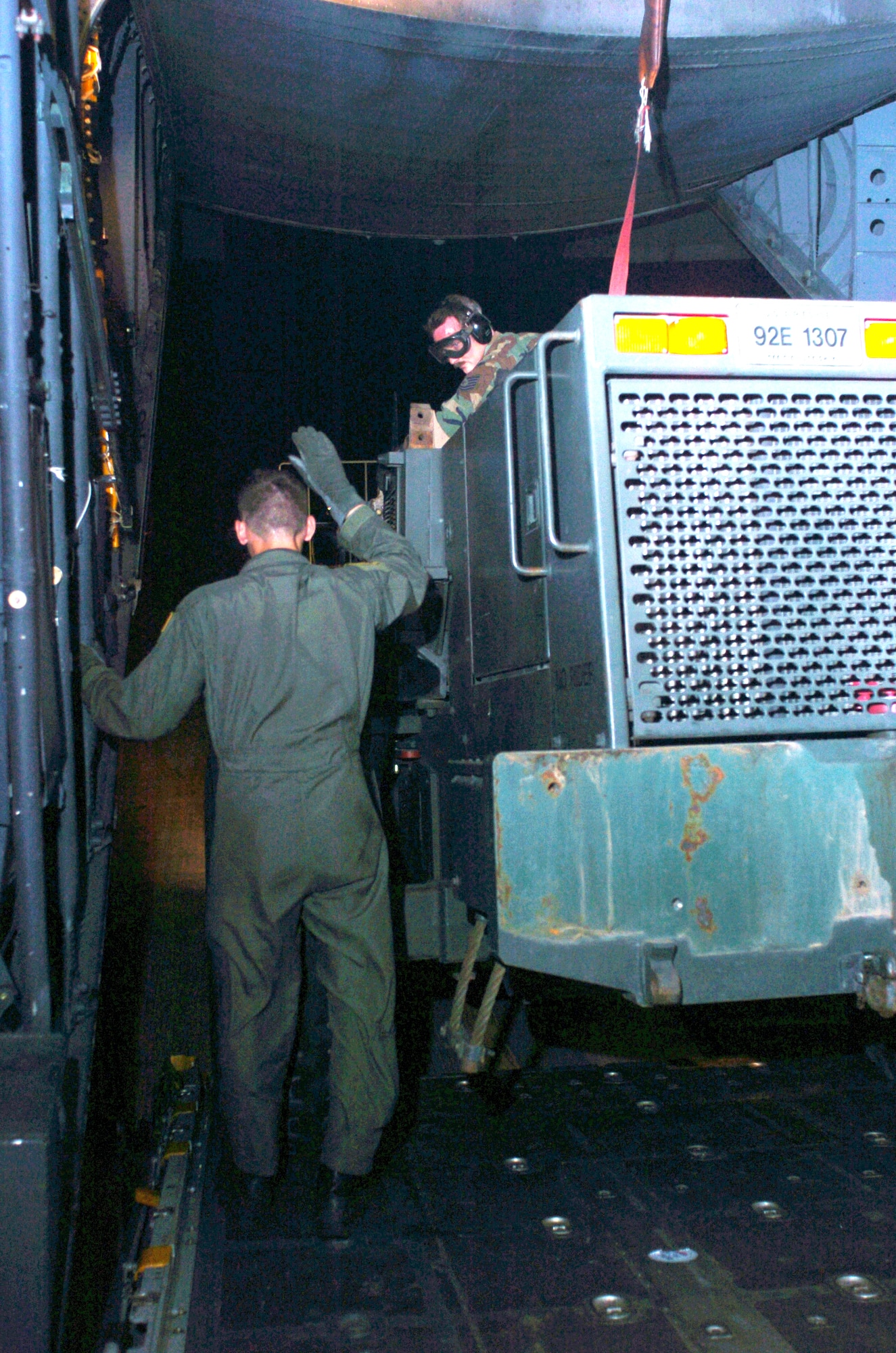 LANGKAWI, Malaysia -- Airman 1st Class Nick Truman guides a forklift being delivered here off of a C-130 Hercules for humanitarian aid supporting Operation Unified Assistance.  More than 13,000 Marines, Sailors, Airmen, Soldiers and Coast Guardsmen with Combined Support Force 536 are working with international militaries and nongovernmental organizations to aid people in Thailand, Sri Lanka and Indonesia after a magnitude 9.0 earthquake Dec. 26 triggered devastating tsunamis.  Airman Truman is deployed with the 374th Air Expeditionary Wing supporting Operation Unified Assistance.  (U. S. Navy photo by Petty Officer 2nd Class Katrina Beeler)
