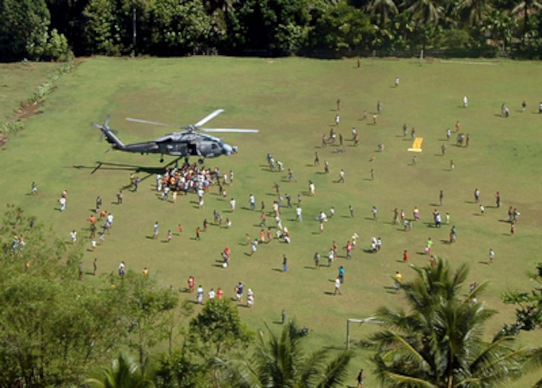 A U.S. Navy helicopter arrives with food, water and humanitarian supplies for tsunami survivors on Sumatra, Indonesia, on Jan. 7, 2005. Helicopters assigned to Carrier Air Wing 2 aboard USS Abraham Lincoln (CVN 72) are providing humanitarian assistance to areas devastated by the Dec. 26, 2004, tsunami that struck the Indian Ocean. The Lincoln Carrier Strike Group is currently operating in the Indian Ocean off the coasts of Indonesia and Thailand as part of Operation Unified Assistance. 