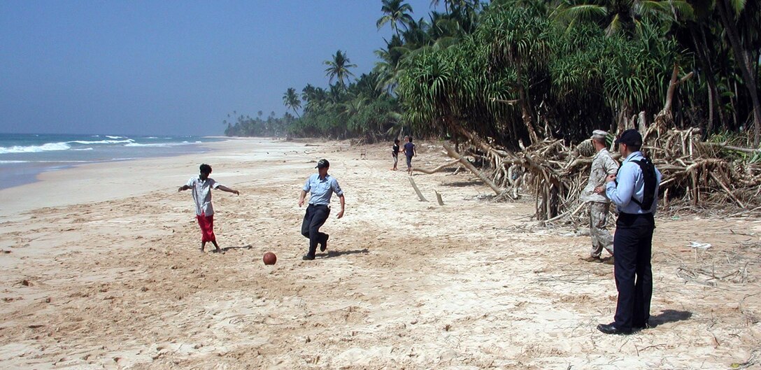 Marines and Sailors play soccer on the beach with Sri Lankan kids. The 15th Marine Expeditionary Unit (Special Operations Capable) provided desperately needed humanitarian aid to cities and villages along Sri Lanka's southern coastline.