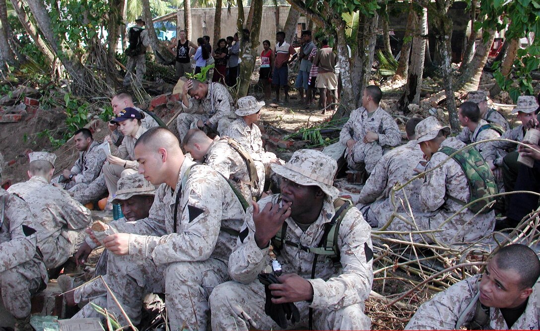 Marines and Sailors of the 15th Marine Expeditionary Unit (Special Operations Capable) break for chow as the locals here look on. The 15th Marine Expeditionary Unit (Special Operations Capable) provided desperately needed humanitarian aid to cities and villages along Sri Lanka's southern coastline.