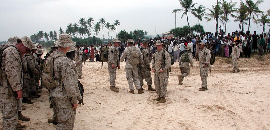 Marines and Sailors stand in formation before heading back to USS Duluth while local citizens watch. The 15th Marine Expeditionary Unit (Special Operations Capable) provided desperately needed humanitarian aid to cities and villages along Sri Lanka's southern coastline.