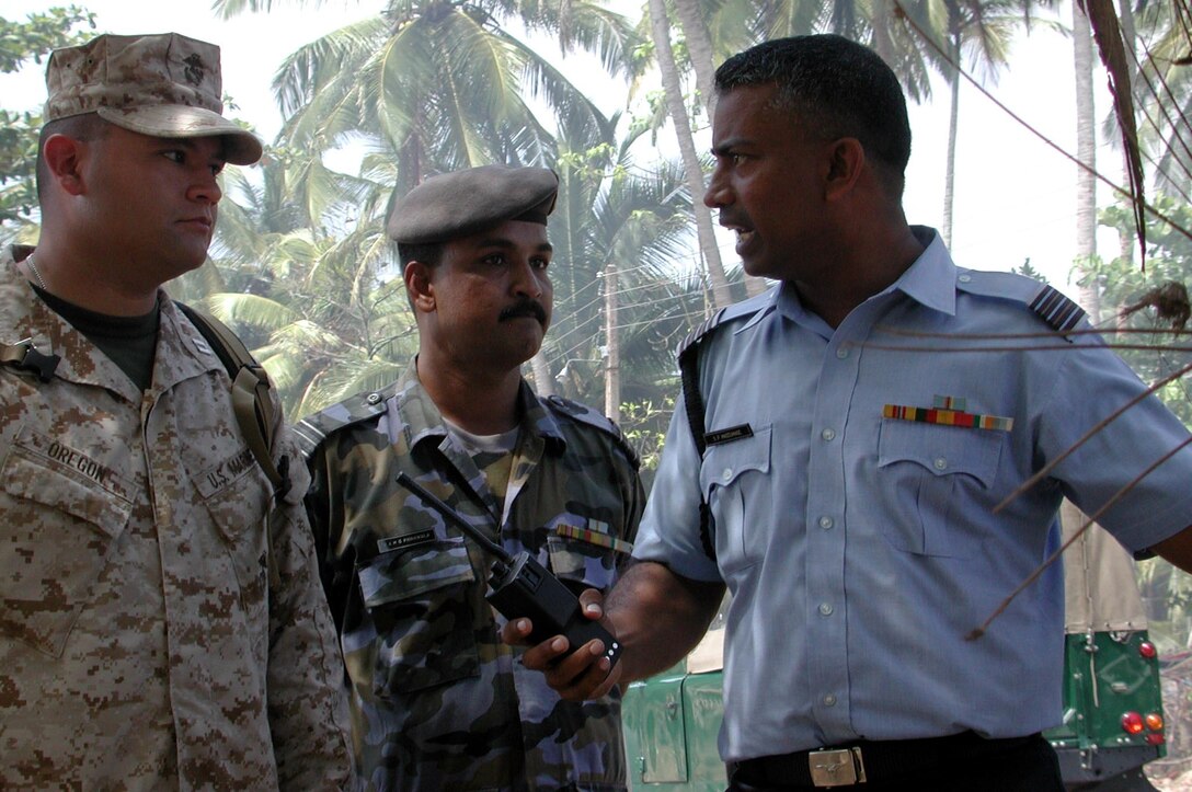 Capt Rogelio Oregon talks to Sri Lankan military officials while coordinating humanitarian relief efforts here. The 15th Marine Expeditionary Unit (Special Operations Capable) provided desperately needed humanitarian aid to cities and villages along Sri Lanka's southern coastline.