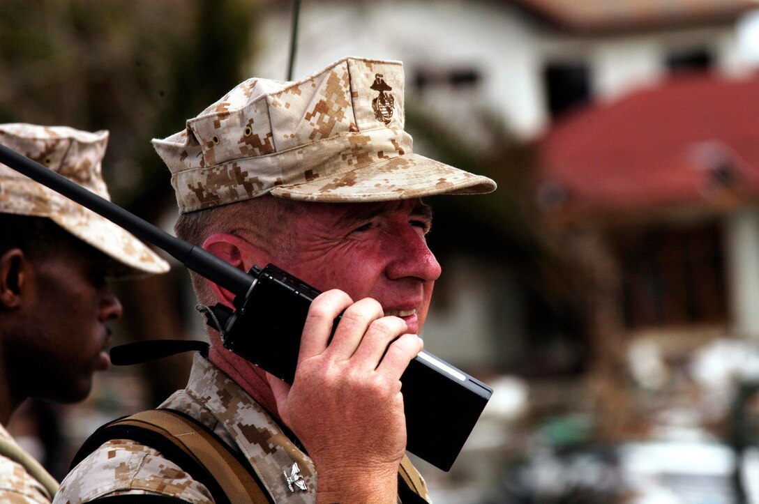 MEULABOH, Indonesia (Jan. 10, 2005) -- Colonel T.C. Greenwood, commanding officer of the 15th Marine Expeditionary Unit (Special Operations Capapble) communicates with his forces using a tactical radio. The 15th MEU (SOC) has been providing desperately needed humanitarian aid to cities and villages along more than 150 miles of Sumatra's western coastline.  (Photo by Gunnery Sgt. Robert Knoll)