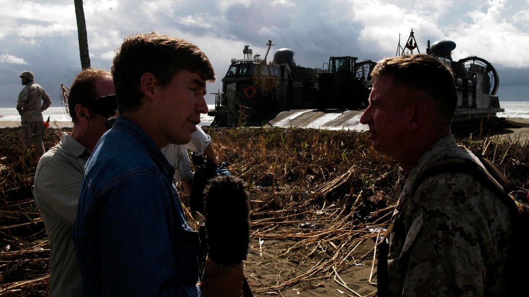 MEULABOH, Indonesia (Jan. 10, 2005) -- Greg Palkot, a correspondent with Fox News interviews Col. Tom Greenwood, commanding officer of the 15th Marine Expeditionary Unit (Special Operations Capable) on the beach here. The 15th MEU (SOC) has been providing desperately needed humanitarian aid to cities and villages along more than 150 miles of Sumatra's western coastline.  (Photo by Gunnery Sgt. Robert Knoll)