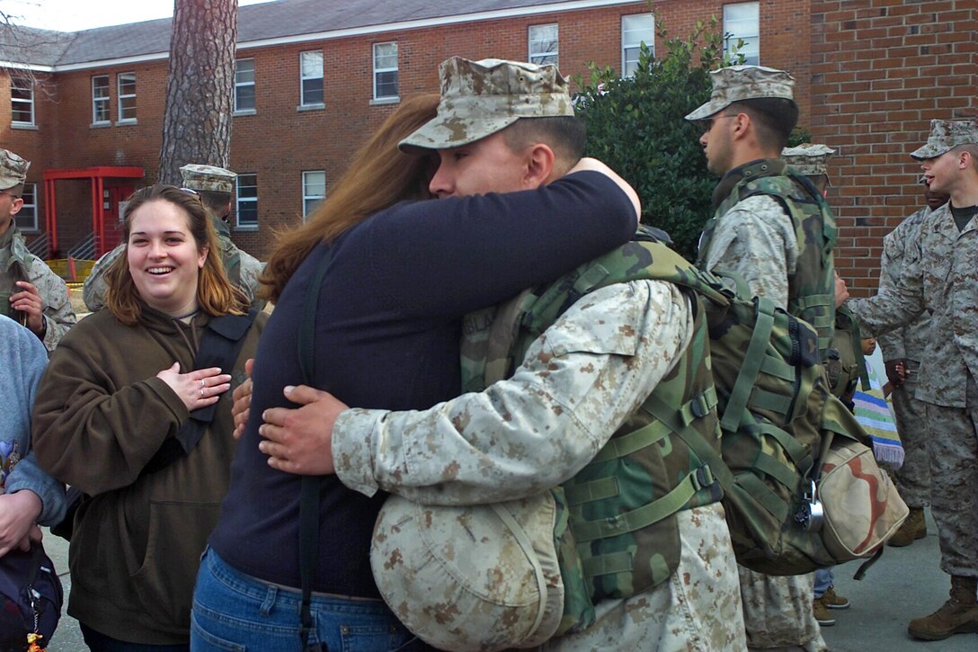 Sgt. John T. Tremblay of the 24th Marine Expeditionary Unit hugs his wife after arriving back at Camp Lejeune, N.C., from a seven-month deployment to Iraq.::n::Tremblay is with Bravo Battery attached to Battalion Landing Team 1st Battalion, 2nd Marines – the 24th MEU’s ground combat element.::n::::n::(Official USMC Photo by Sgt. Zachary A. Bathon. This photo is cleared for release.)::n::