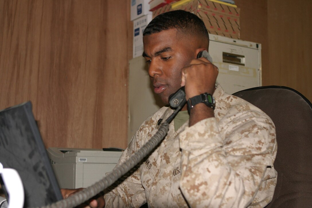 Sergeant Cryst Banks, a 21-year-old personnel administration clerk, Washington D.C. native and 2d Marine Division Morale Welfare and Recreation liaison talks to his contacts to arrange for entertainment on the camps to boost morale.  U.S. Marine Corps photo by Sgt. Stephen D'Alessio (RELEASED)