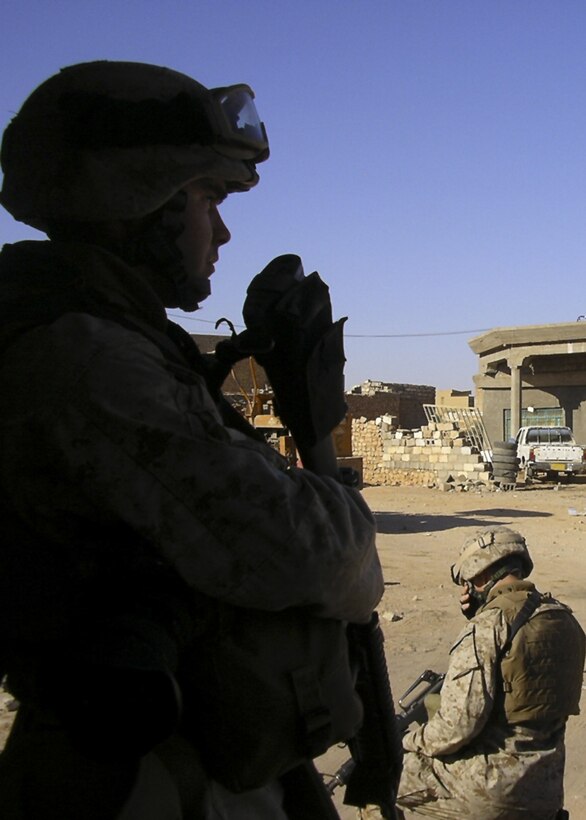 HIT, Iraq- Lance Cpl. Shane S. Keller, a combat photographer with Regimental Combat Team-2, looks out into the village during an operation here.  He was deployed to Iraq for a year. The Harrisburg, Penn. native's job was to document anything that the RCT was involved in. (Courtesy of Interpreter of 3rd Battalion, 25th Marines)