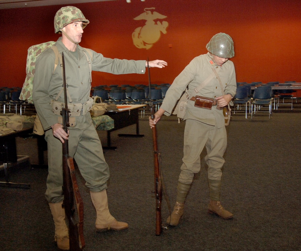 Lt. Col. Brian Kerl, left, and Lance Cpl. Ryan James act out the Battle of Tarawa at Martini Hall Nov. 2.