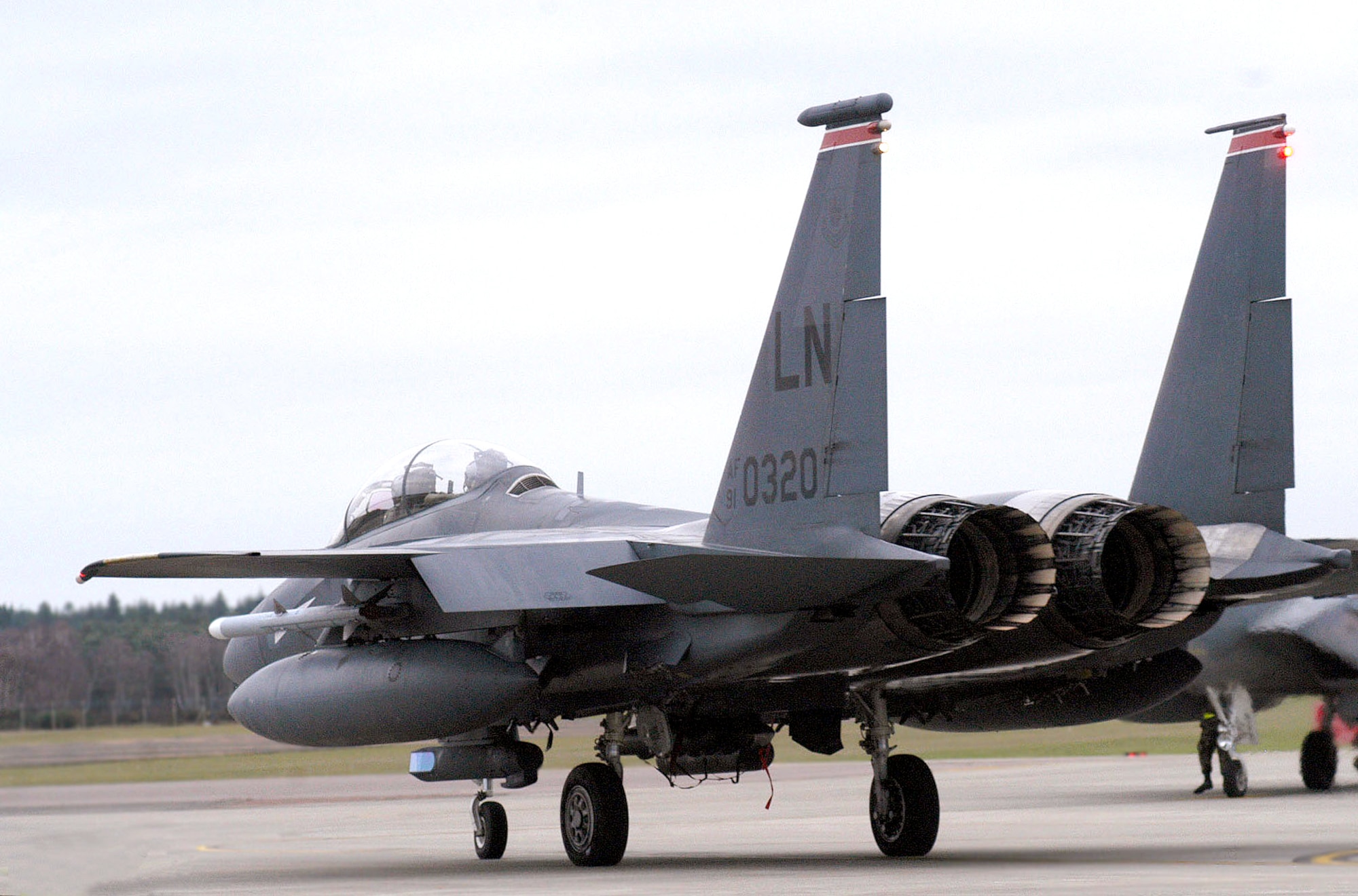 ROYAL AIR FORCE LAKENHEATH, England -- A 494th Fighter Squadron F-15E Strike Eagle crew awaits clearance to take off here Jan. 7.  The aircraft was equipped with the new Sniper Advanced Targeting Pod.  The flight also marked the first time an F-15E carried a GBU-38 Joint Direct Attack Munition.  (U.S. Air Force photo by Senior Airman Lynne Neveu)
