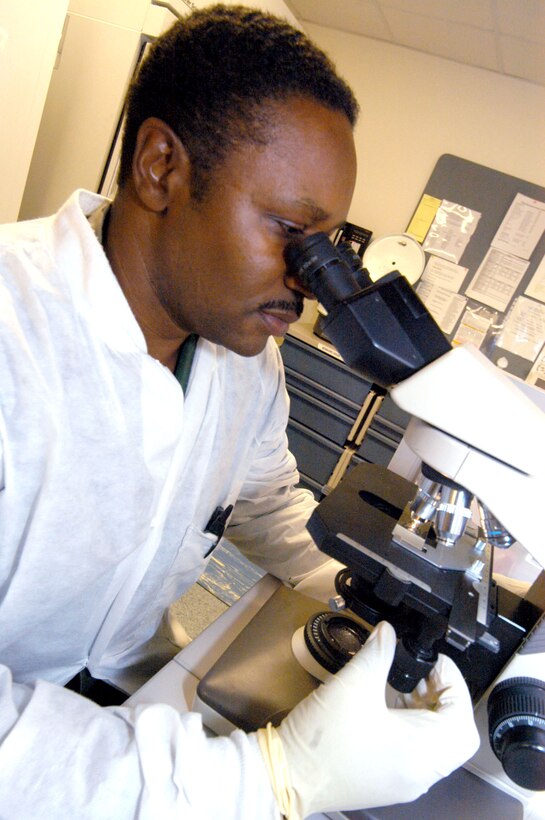 ROBINS AIR FORCE BASE, Ga. -- Master Sgt. Roderick Capers analyzes a fluid sample on a slide.  He is superintendent of lab service for the 78th Medical Group here.  Lab technicians support the group's various departments, analyzing hundreds of fluid and tissue samples each day to help physicians diagnose patient ailments.  (U.S. Air Force photo by Sue Sapp)