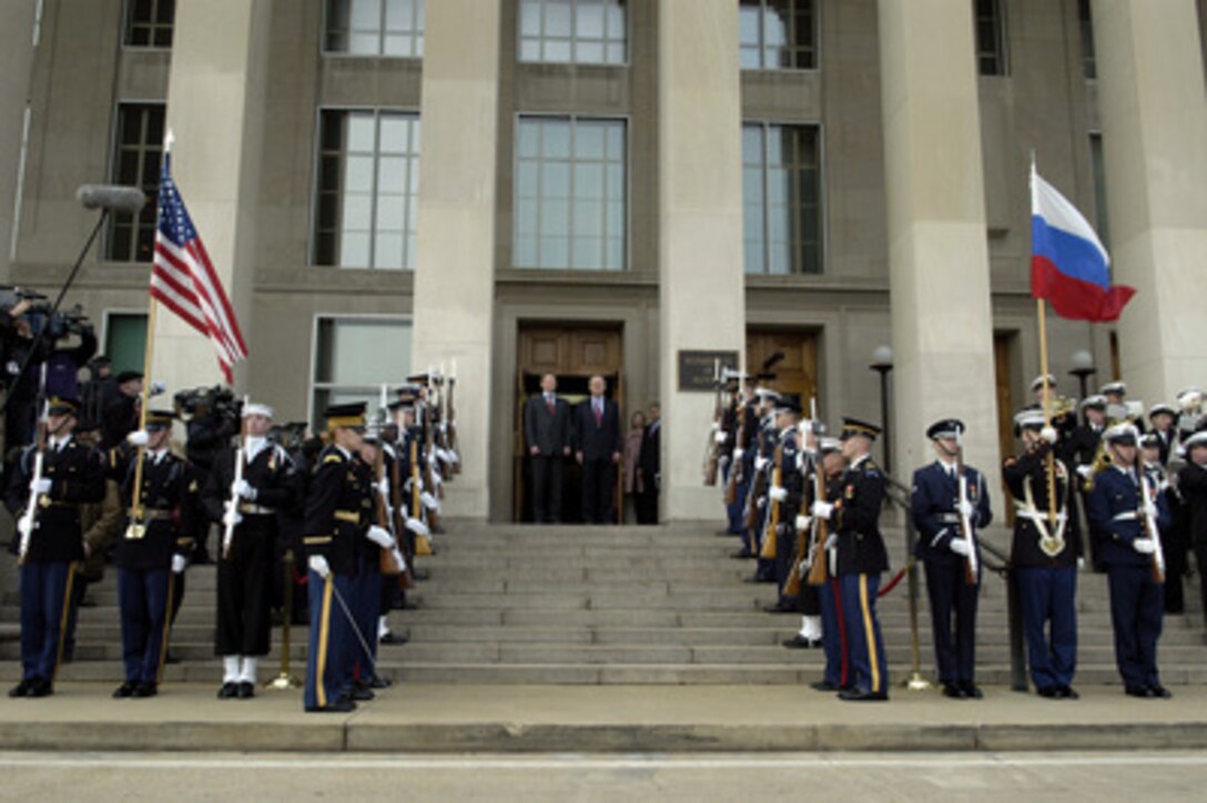 Russian Minister of Defense Sergey Ivanov (top of steps left) and Secretary of Defense Donald H. Rumsfeld (right) listen as the Russian National Anthem is played during a Pentagon honor cordon welcoming Ivanov on Jan. 11, 2005. 