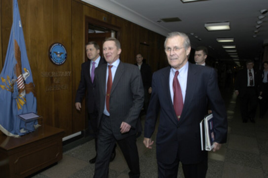 Secretary of Defense Donald H. Rumsfeld (right) escorts Russian Minister of Defense Sergey Ivanov (center) and Russian Ambassador to the U.S. Yuriy Ushakov (left) to their bilateral meeting on Jan. 11, 2005. Rumsfeld and Ivanov will meet to discuss defense issues of mutual interest. 