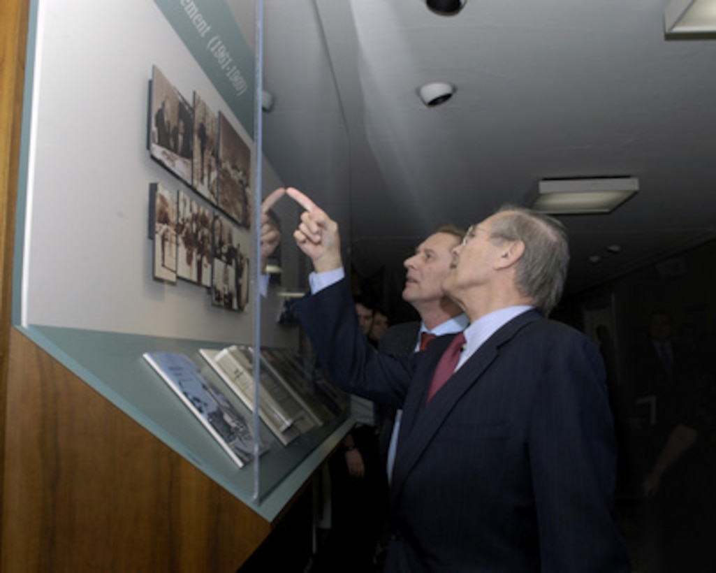 Secretary of Defense Donald H. Rumsfeld (right) indicates to Russian Minister of Defense Sergey Ivanov (left) a photograph of himself as a young congressman meeting with President Dwight D. Eisenhower in a Pentagon exhibit on Jan. 11, 2005. Rumsfeld and Ivanov are meeting to discuss defense issues of mutual interest. 