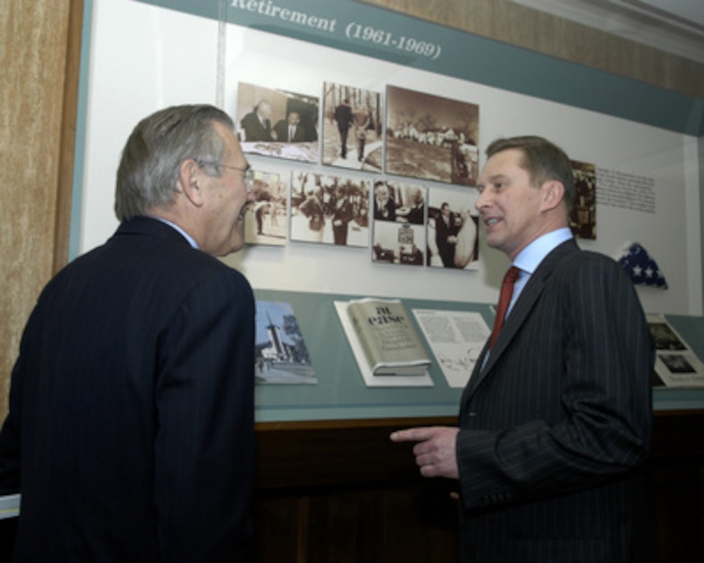 Secretary of Defense Donald H. Rumsfeld (left) and Russian Minister of Defense Sergey Ivanov (right) view a photograph of Rumsfeld as a young congressman meeting with President Dwight D. Eisenhower in a Pentagon exhibit on Jan. 11, 2005. Rumsfeld and Ivanov are meeting to discuss defense issues of mutual interest. 