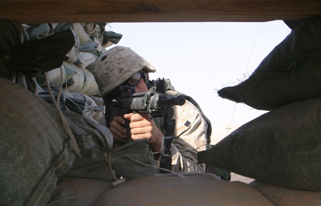 AL ASAD, Iraq - Private First Class Mathew Shaw, Lima Co. 3rd Battalion, 25th Marines takes aim through the secondary fighting position at his tower here, April 12.