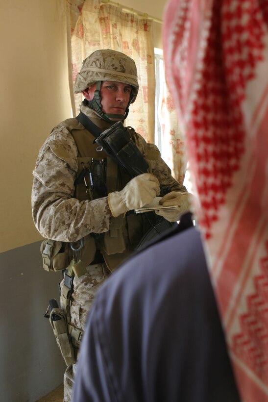 Al Ubayd, Iraq (April 12, 2005)- Staff Sgt. Christopher A. Griffeth, the civil affairs chief with 5th Civil Affairs Group, 3rd Battalion, 2nd Marine Regiment, Regimental Combat Team-2 interviews a local gas station owner on the amount of gas the area uses, needs and the amount of supplies they need here April 12. Official U.S. Marine Corps photo by Lance Cpl. Lucian Friel (RELEASED)