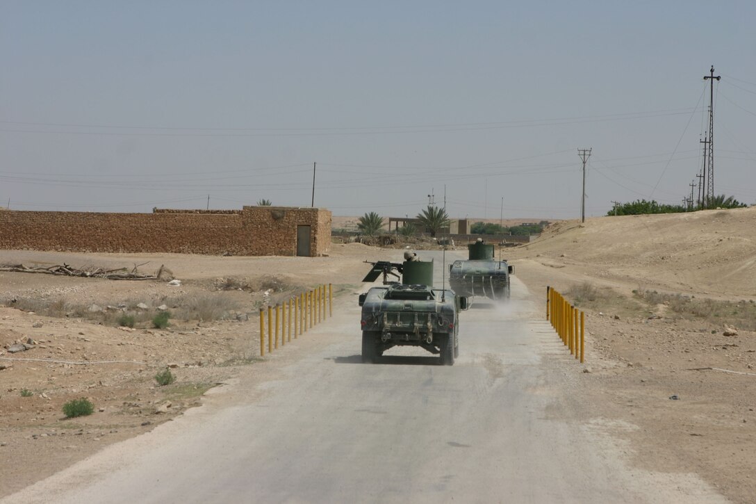 Al Ubayd, Iraq (April 12, 2005)- Marines with 5th Civil Affairs Group, Security Platoon and the Information Operations cell, 3rd Battalion, 2nd Marine Regiment, Regimental Combat Team-2 convoy to a local gas station and water treatment facility here to inspect a stage of the treatment project and to interview the gas station owner Official U.S. Marine Corps photo by Lance Cpl. Lucian Friel (RELEASED)