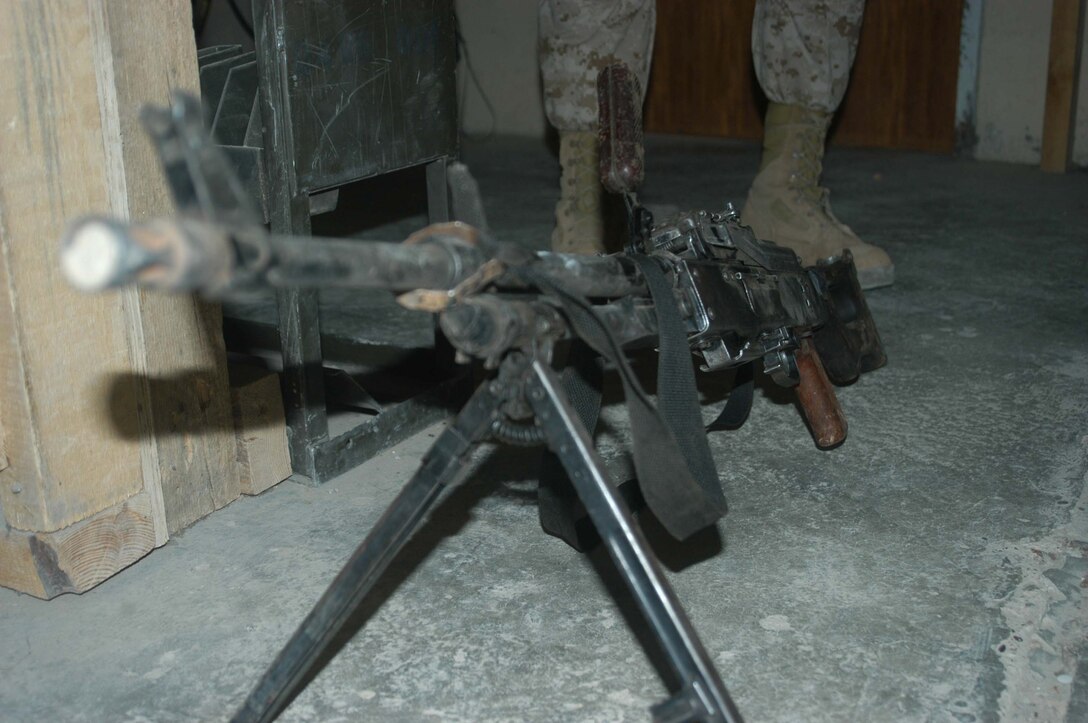 CAMP HURRICANE POINT Ar Ramadi, Iraq (May 12, 2005) - Marines with 1st Platoon, Company W, 1st Battalion, 5th Marine Regiment, took a PKM machine gun and several other weapons and ammunition from insurgents during a mission in the city. The warriors killed three insurgents and discovered a rocket propelled grenade launcher, a PKM machine gun with more than 100 armor-piercing rounds, a Romanian assault rife, three AK-47 assault rifles and more than 300 rounds of ammunition. Photo by Cpl. Tom Sloan