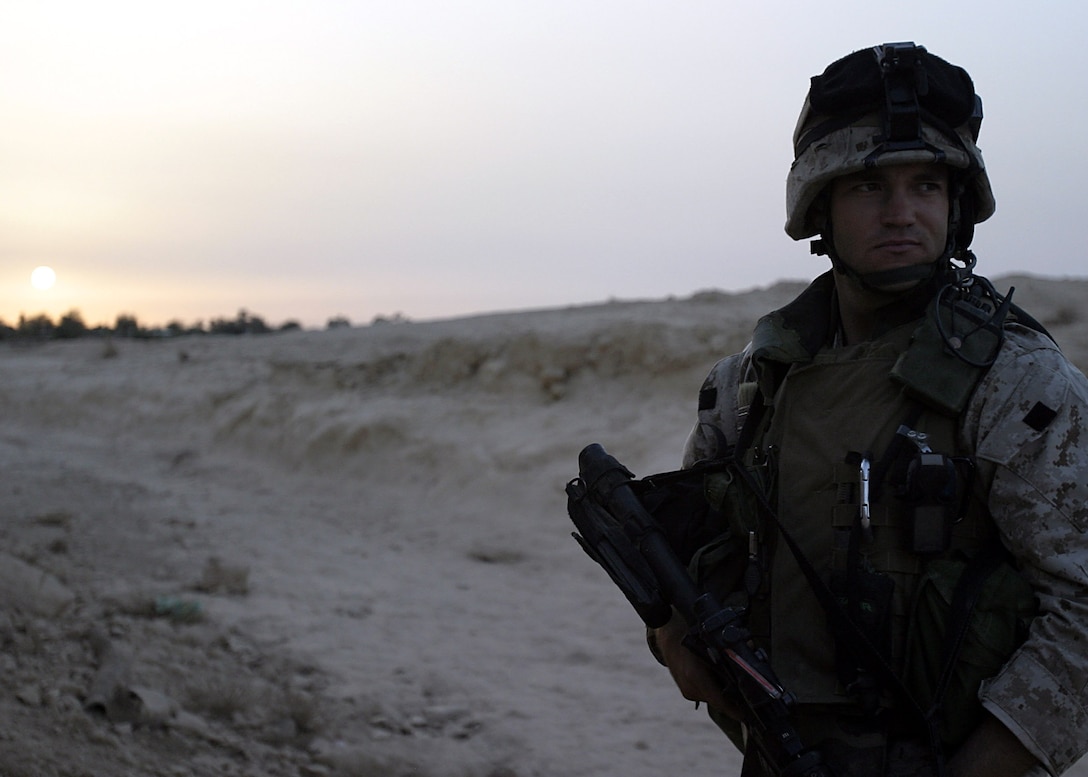 Dam Village, Al Anbar, Iraq  - Toledo, Ohio, native, Sgt Scott E. Campbell, a 30-year-old squad leader with 2nd platoon, Lima Company, 3/25, looks at the area his squad will use as an observation post.