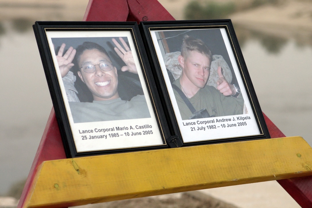 CAMP BAHARIA, Iraq - A Navy corpsman insignia a grieving sailor left behind rests alongside Lance Cpl. Mario Castillo's and Lance Cpl. Andrew Kilpela's photographs atop a stand during a memorial service honoring their memories here June 12.  The two engineers passed away June 10 when an improvised explosive device detonated near their vehicle in a roadway outside Fallujah.