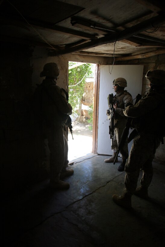 050912-M-8489S-001, 002 AR RAMADI, Iraq (September 12, 2005) - Marines with Company A, 1st Battalion, 5th Marine Regiment stand by for during a patrol through the streets of Ramadi. The Marines from 2nd platoon had been on a patrol through the city when their vehicles came under attack from insurgents. Photo by Cpl. Shane Suzuki