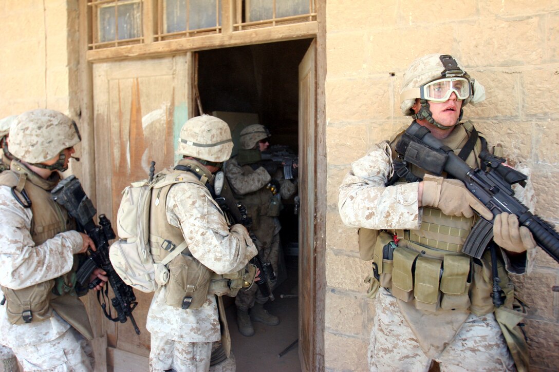 050912-M-8489S-007 AR RAMADI, Iraq (September 12, 2005) - A Marine stands guard while the rest of his squad searches through A Marine with Company A, 1st Battalion, 5th Marine Regiment stands guard outside a house while the rest of his squad searches for weapons and enemies. This raid was one of many operations 1/5 did to help incoming 3rd Battalion, 7th Marine Regiment get used to the area. Photo by Cpl. Shane Suzuki