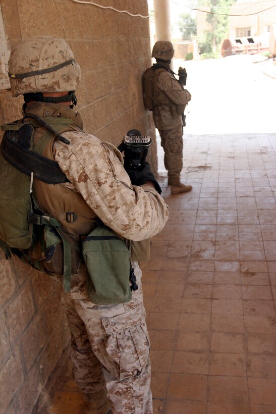 050912-M-8489S-009 AR RAMADI, Iraq (September 12, 2005) - Two Marines stand guard while the rest of 2nd Platoon, 1st Battalion, 7th hunts for the insurgents who attacked their patrol earlier in the day. The patrol was cut short when an improvised explosive device was spotted on the side of the road. Soon after the IED was destroyed, the platoon came under attack. Photo by Cpl. Shane Suzuki