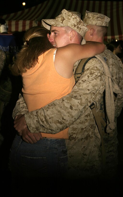 MARINE CORPS BASE CAMP LEJEUNE, N.C. - A Marine with 1st Battalion, 6th Marine Regiment hugs his loved one shortly after arriving here Oct. 12.  The unit returned home after conducting seven months of security and stability operations in and around Fallujah, Iraq.