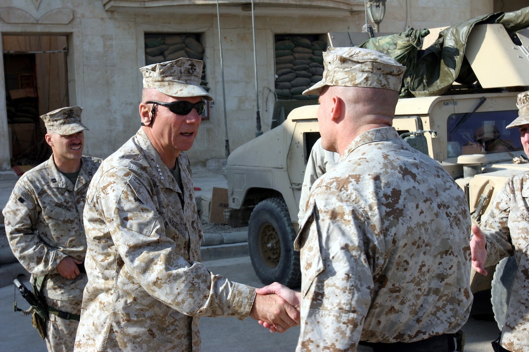 AR RAMADI, Iraq (December 7, 2005) - General Michael Hagee, commandant of the Marine Corps, shakes hands with Lt. Col. Roger Turner, commanding officer of 3rd Battalion, 7th Marine Regiment at Hurricane Point Dec. 7. Photo by Cpl. Shane Suzuki