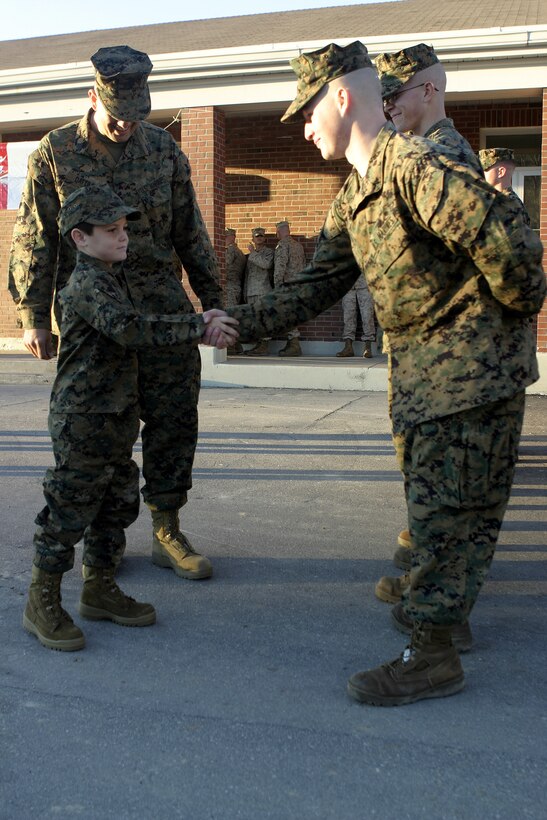 MARINE CORPS BASE CAMP LEJEUNE, N.C. - A Marine with 1st Battalion, 9th Marine Regiment shakes hands with six-year-old Brandon Rasnick outside a mess hall here Dec. 12.  Brandon and his family visited numerous training grounds and units throughout the base while on a trip sponsored by the Make-a-Wish foundation to grant his wish of training alongside United States Marines.  Brandon is a boy from Lehigh Acres, Fla. who has cystic fibrosis, a genetic lung disorder.