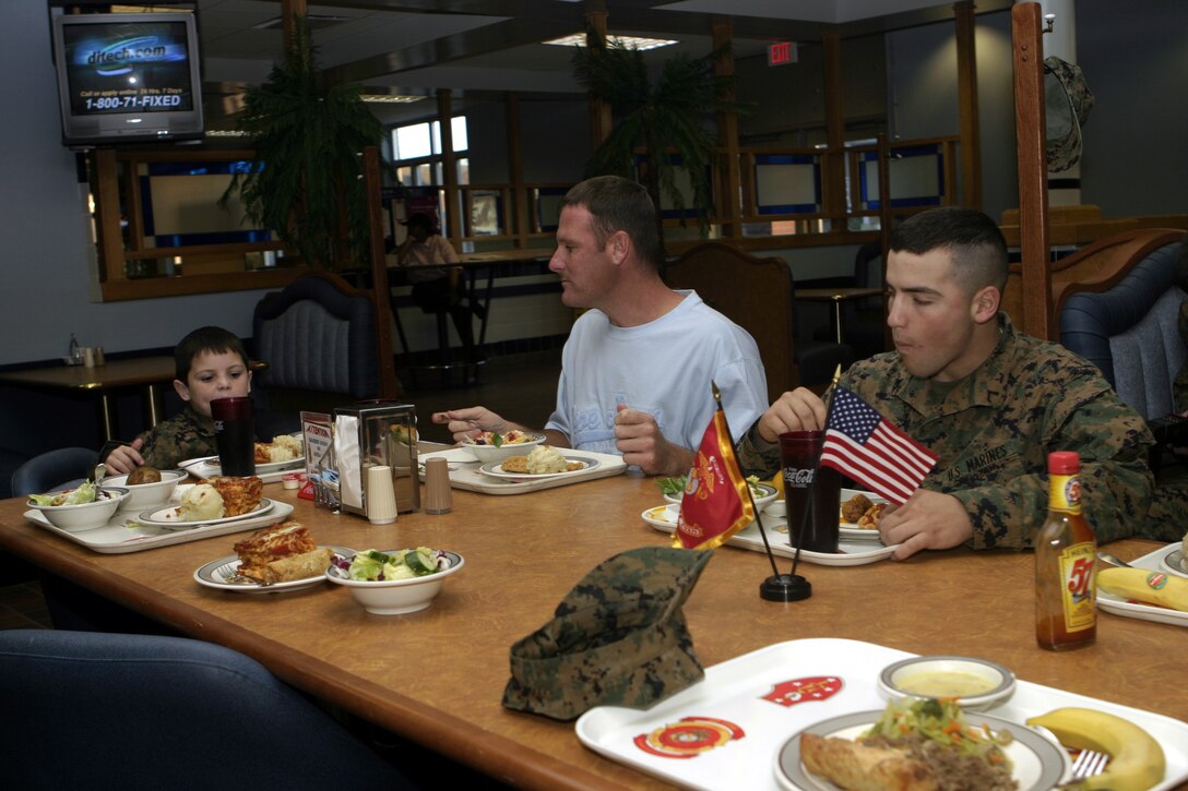 MARINE CORPS BASE CAMP LEJEUNE, N.C. - Personnel with 1st Battalion, 9th Marine Regiment dine with six-year-old Brandon Rasnick and his family inside a mess hall here Dec. 12.  Brandon and his family visited numerous training grounds and units throughout the base while on a trip sponsored by the Make-a-Wish foundation to grant his wish of training alongside United States Marines.  Brandon is a boy from Lehigh Acres, Fla. who has cystic fibrosis, a genetic lung disorder.