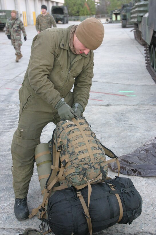 MARINE CORPS BASE CAMP LEJEUNE, N.C. (Dec. 12, 2005)- A Marine with 2nd Assault Amphibian Battalion adjusts his gear after a five day training exercise where the Marines of 2nd AAB got back to the basics of amphibious assault. (Official U.S. Marine Corps photo by Lance Cpl. Lucian Friel (RELEASED)