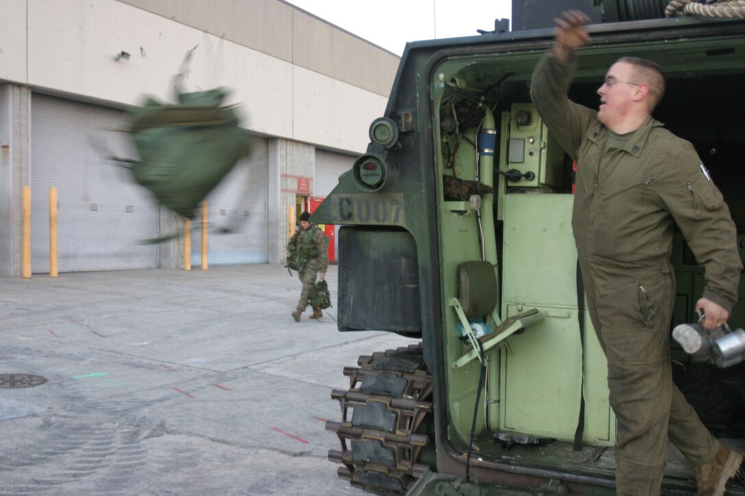 MARINE CORPS BASE CAMP LEJEUNE, N.C. (Dec. 12, 2005)- A Marine with 2nd Assault Amphibian Battalion adjusts gets his pack out of his amphibious assault vehicle after a long five-day training exercise where the Marines of 2nd AAB got back to the basics of amphibious assault. This was the first time in about a year that the battalion trained together and not as individual companies. (Official U.S. Marine Corps photo by Lance Cpl. Lucian Friel (RELEASED)