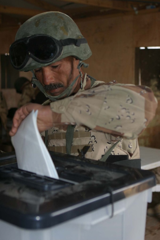 HADITHA DAM, Iraq (Dec. 12, 2005) - An Iraqi soldier casts a ballot here during early Iraqi elections Dec. 12. The soldiers got a chance to vote before the actual Iraqi elections on Dec. 15 because they will be providing security all around the country at voting sites. (Official Marine Corps photo by Cpl. Adam C. Schnell)