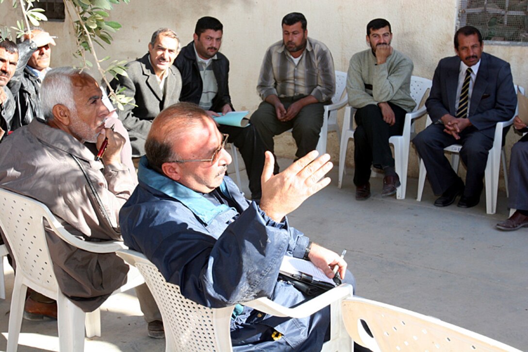 The manager of the local phosphate plant presents an idea to 6th Civil Affairs Group's Civil-Military Operations Center staff. The CAG runs the CMOC in order to facilitate reconstruction of the Al Qaim region.