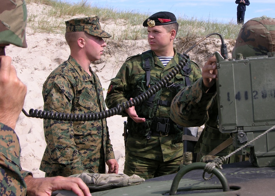 USTKA TRAINING RANGE, Poland -- Corporal Dmitry Polosov translates for a Russian officer during a noncombatant evacuation operation during exercise Baltic Operations 2005. Polosov as well as Marines from 2nd Battalion 23rd Marines recently participated in the annual exercise involving more than 500 troops from 11 countries to improve interoperability between allies and Partnership for Peace nations.