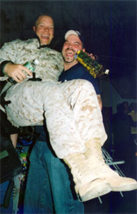 Cpl. Billy Vallely of 6th Communication Battalion is hoisted up by his brother-in-law, in a joyful reunion after not seeing each other for eight month while Vallely was on deployment to Iraq.