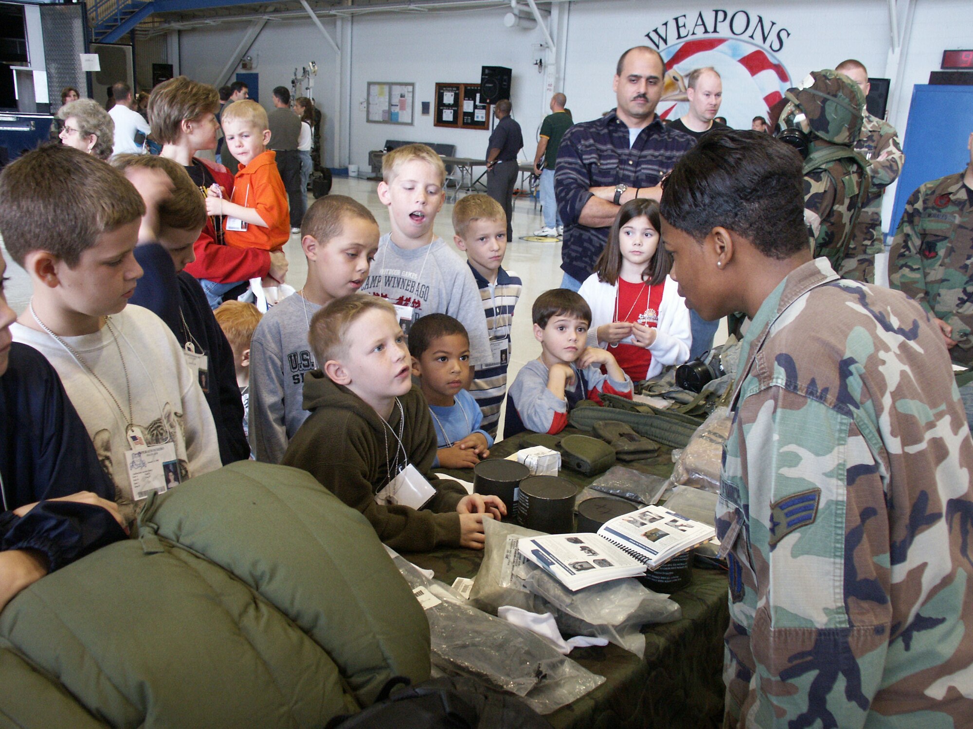 EGLIN AIR FORCE BASE, Fla. -- Senior Airman Tierra Cope explains mobility bags to some of the children who attended Operation Hero here Jan. 8.  The event was designed to help children better understand what a deployment is and what happens when their parents deploy.  Airman Cope is a mobility apprentice in the 33rd Maintenance Operations Squadron.  (U.S. Air Force photo by Staff Sgt. Robert Zoellner)