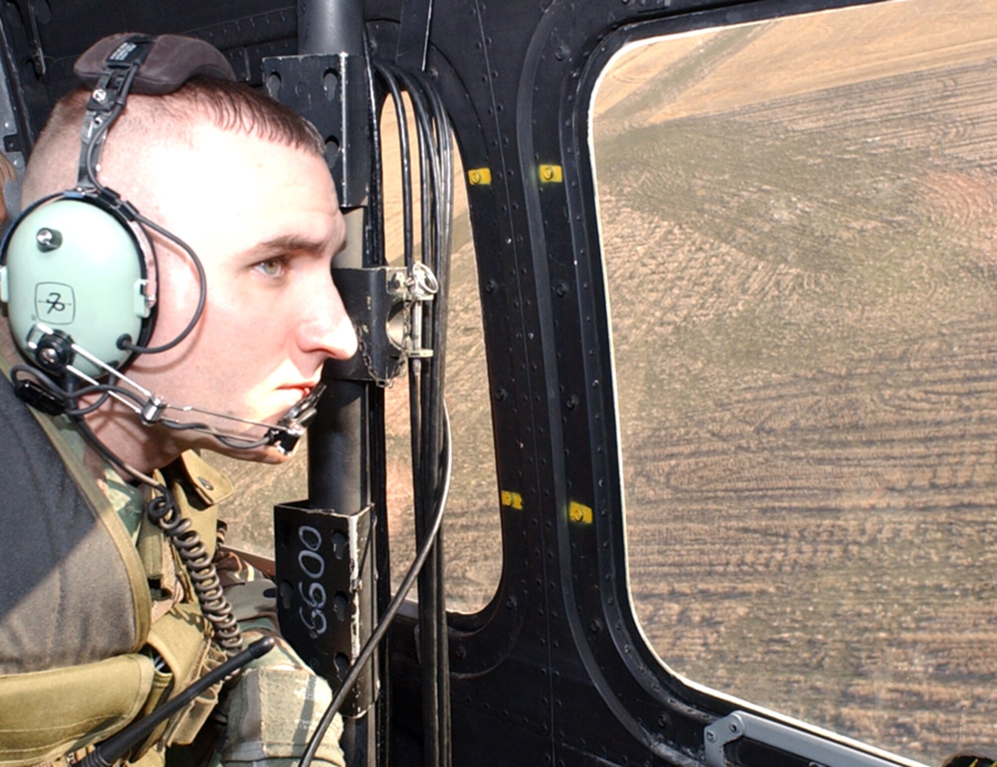 OVER MONTANA -- Senior Airman Michael Watts conducts an aerial sweep of a missile launch facility in Malmstrom Air Force Base's missile complex before maintenance begins.  He is assigned to the 741st Missile Security Forces Squadron.  (U.S. Air Force photo by Staff Sgt. Andeelynn Fifrick)