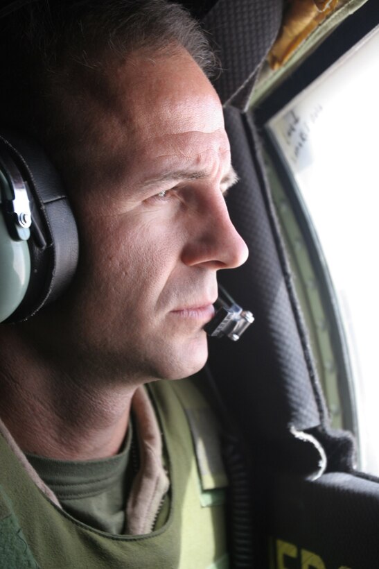 AL ASAD, Iraq?Staff Sgt. Chris K. Belt, crew chief, from Pensacola, Fla., keeps a sharp eye on the F/A-18 Hornet jet as it refuels over the Al Anbar province July 11.  Marine Aerial Refueler Transport Squadron 252 delivered its 10 millionth pound of fuel and marked another first for the combat deployed Hercules squadron.