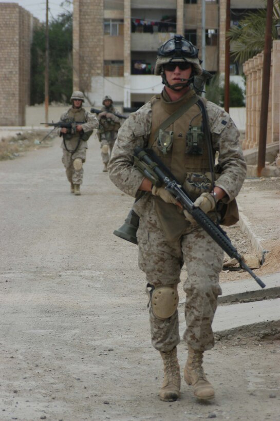 AR RAMADI, Iraq (April 9, 2005) -Corporal Nicholas J. Boire, a 22-year-old squad leader, with 2nd Squad, 2nd Platoon, Company C, 1st Battalion, 5th Marine Regiment, leads the way for his Marines during a patrol through a neighborhood here known as the "Ghetto." The Minnetonka, Minn., native and other Marines with 2nd Squad, 2nd Platoon, Company C, 1st Battalion, 5th Marines, patrolled the neighborhood and handed out candy to the children and positive and anti-insurgent propaganda pamphlets to Iraqi men. Photo by Cpl. Tom Sloan
