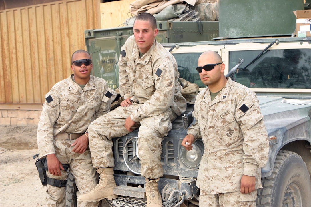 CAMP FALLUJAH, IRAQ -- Lance Cpl. Michael A. Romano, a motor transportation operator and machine gunner for combat train and his fellow Marines from his vehicle were talking after the days mission.  He takes everyday as if it were his first as he ensures Marines are taken where they are needed, supplies are delivered and all logistic needs are taken care of.  Official U.S. Marine Corps Photo by Lance Cpl. Athanasios L. Genos.
