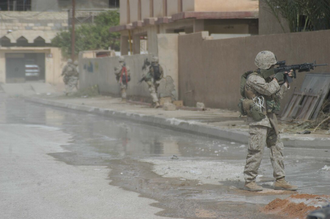 AR RAMADI, Iraq (April 13, 2005) - A Marine with 2nd Platoon, Company A, 1st Battalion, 5th Marine Regiment, posts security down a street here during a patrol. Marines with 2nd Platoon, Company A, 1st Battalion, 5th Marines, conducted a combat patrol through the southern portion of the city where insurgents have actively been engaging coalition forces. Insurgents engaged the leathernecks in drive-by shooting midway through their combat patrol. Photo by Cpl. Tom Sloan